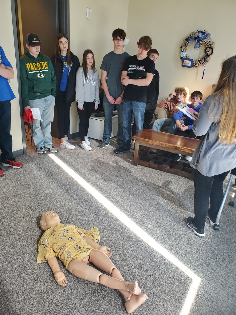 Students viewing a manikin during a EMT scenario 